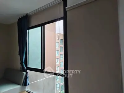 Modern apartment window with city view and elegant curtains