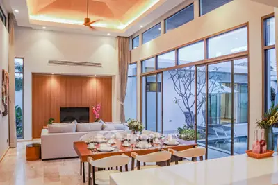 Luxurious open-plan living room with pool view and elegant dining area