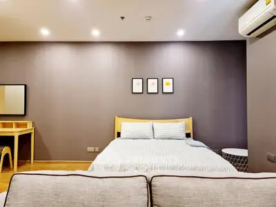 Modern bedroom with cozy bed, stylish decor, and air conditioning unit.