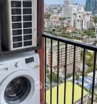 High-rise balcony with washing machine and city view, perfect for urban living.