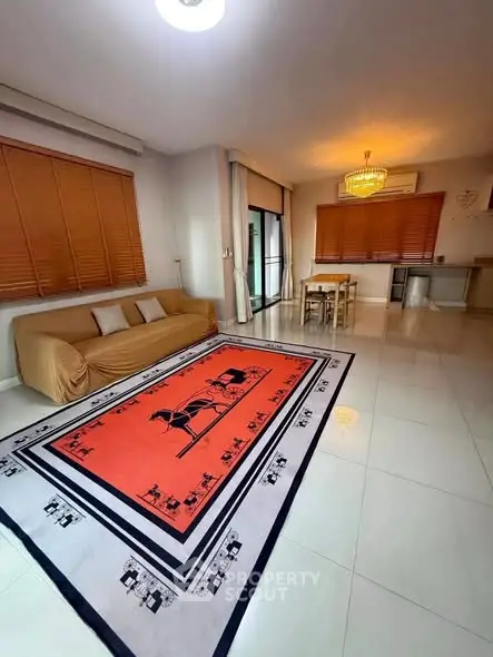 Spacious living room with elegant decor and large windows for natural light.