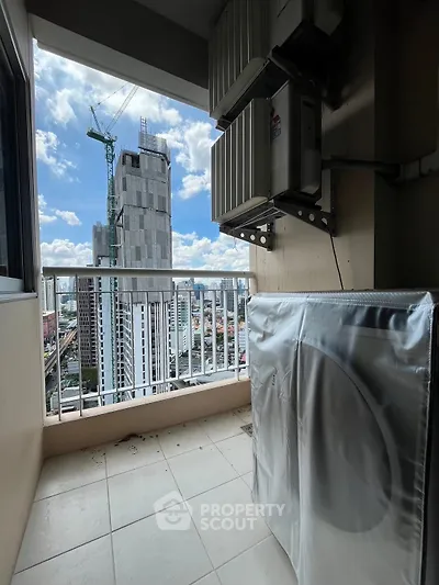 High-rise balcony with cityscape view and air conditioning units