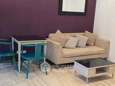 Chic living room with modern sofa, vibrant chairs, and stylish decor