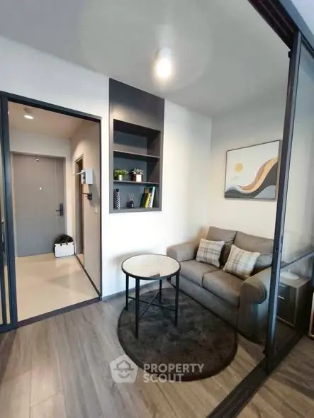 Modern living room with cozy sofa and stylish decor in a contemporary apartment.