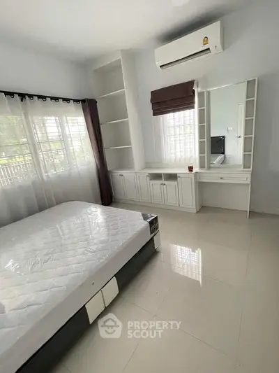 Spacious bedroom with modern air conditioning and built-in storage
