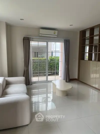 Spacious living room with modern sofa and large window view