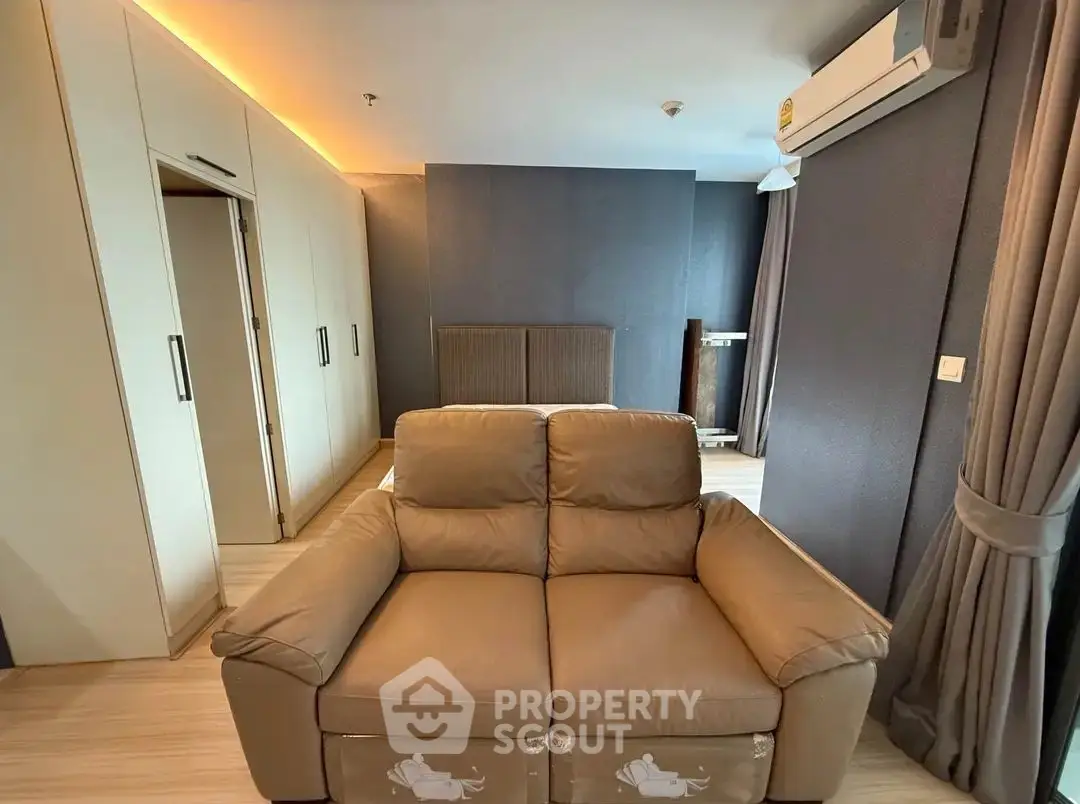 Modern living room with stylish sofa and sleek air conditioning unit