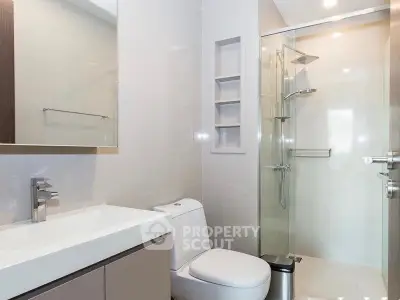 Modern bathroom with sleek fixtures and glass shower enclosure