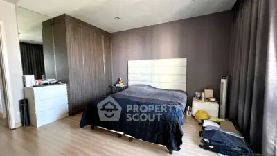 Spacious modern bedroom with sleek design and ample storage space