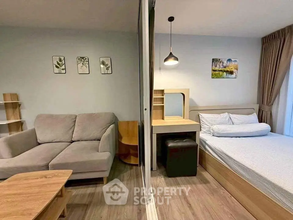 Modern studio apartment with cozy living area and stylish bedroom, featuring elegant decor and natural light.