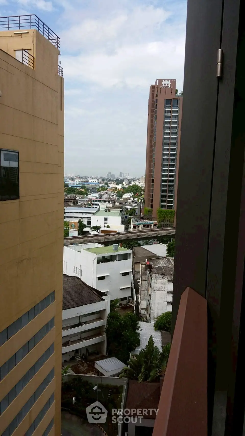 Stunning urban view from high-rise building balcony showcasing cityscape.