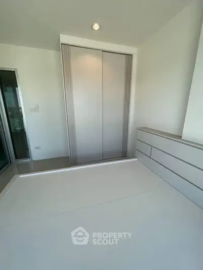 Modern minimalist bedroom with built-in wardrobe and sleek design