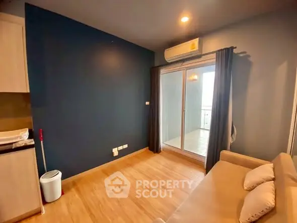 Cozy living room with modern decor and balcony access