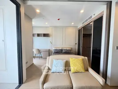 Modern studio apartment with cozy living area and stylish bedroom setup.