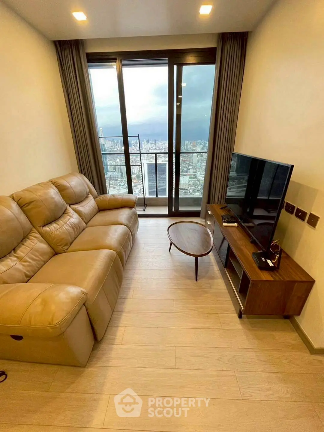 Modern living room with stunning city view and cozy leather sofa.