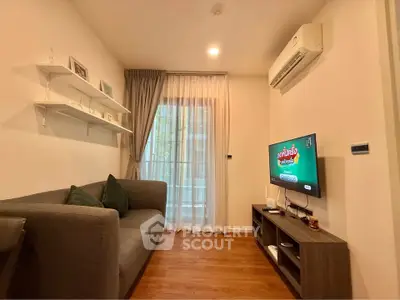 Cozy living room with modern decor and air conditioning, featuring a sleek TV setup.