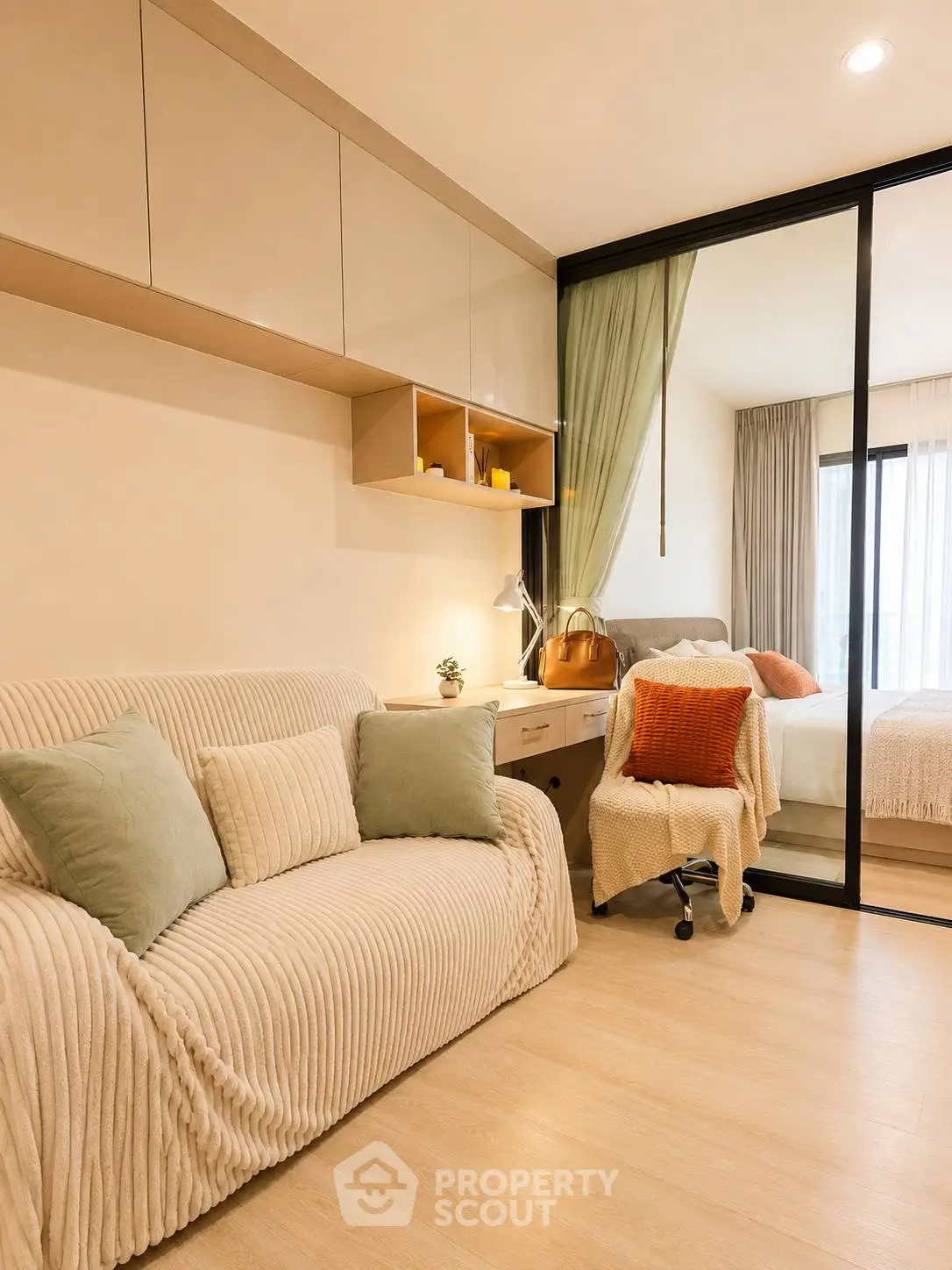 Modern cozy bedroom with stylish decor and sliding glass partition, perfect for urban living.