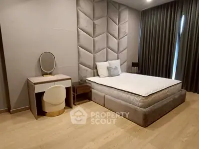 Luxurious bedroom with elegant decor and plush bedding in modern apartment.