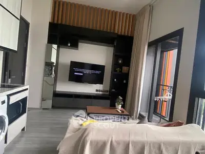 Modern living room with sleek design, large windows, and integrated kitchen appliances.