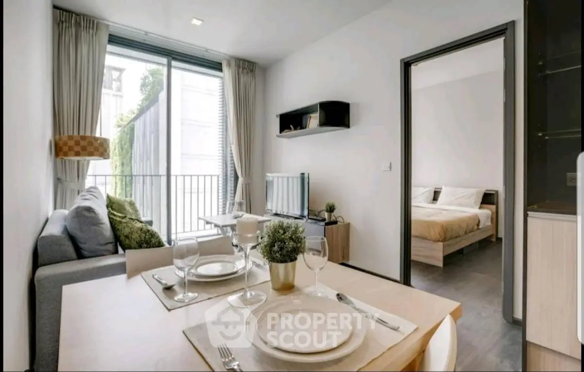 Modern apartment with open living and dining area, featuring stylish decor and natural light.
