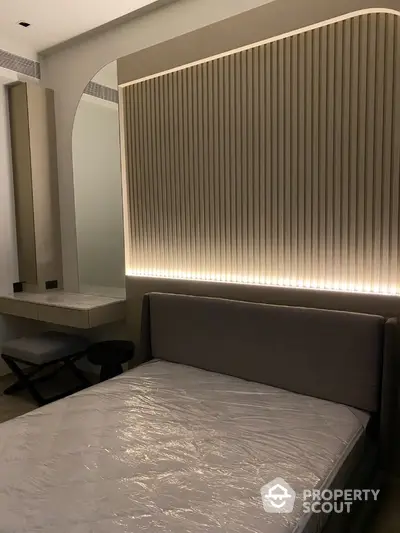 Modern bedroom with stylish headboard and ambient lighting