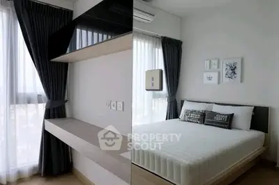 Modern bedroom with sleek design and natural light, featuring stylish decor and cozy ambiance.