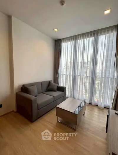 Modern living room with large windows and city view