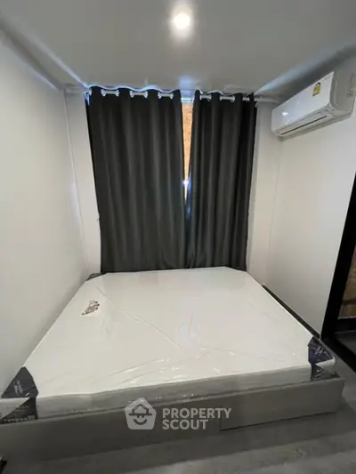 Cozy bedroom with modern air conditioning and blackout curtains, perfect for restful sleep.