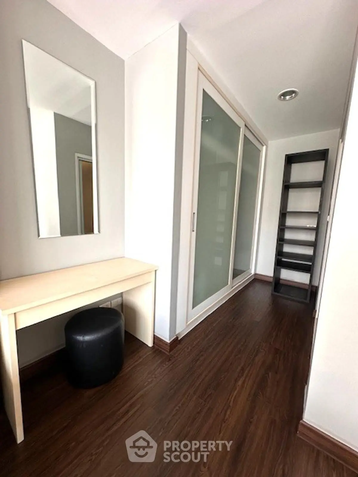 Stylish hallway with wooden flooring and modern furniture