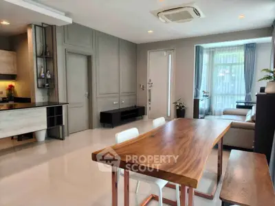 Modern living room with elegant dining area and natural light