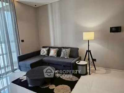 Modern living room with stylish sofa and floor lamp in elegant apartment.