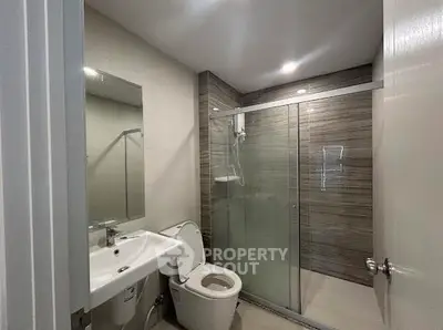 Modern bathroom with glass shower and sleek fixtures