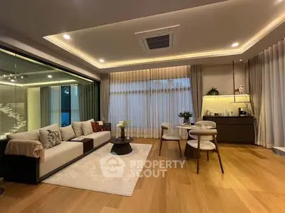 Luxurious living room with modern decor and open layout, featuring elegant lighting and cozy seating area.