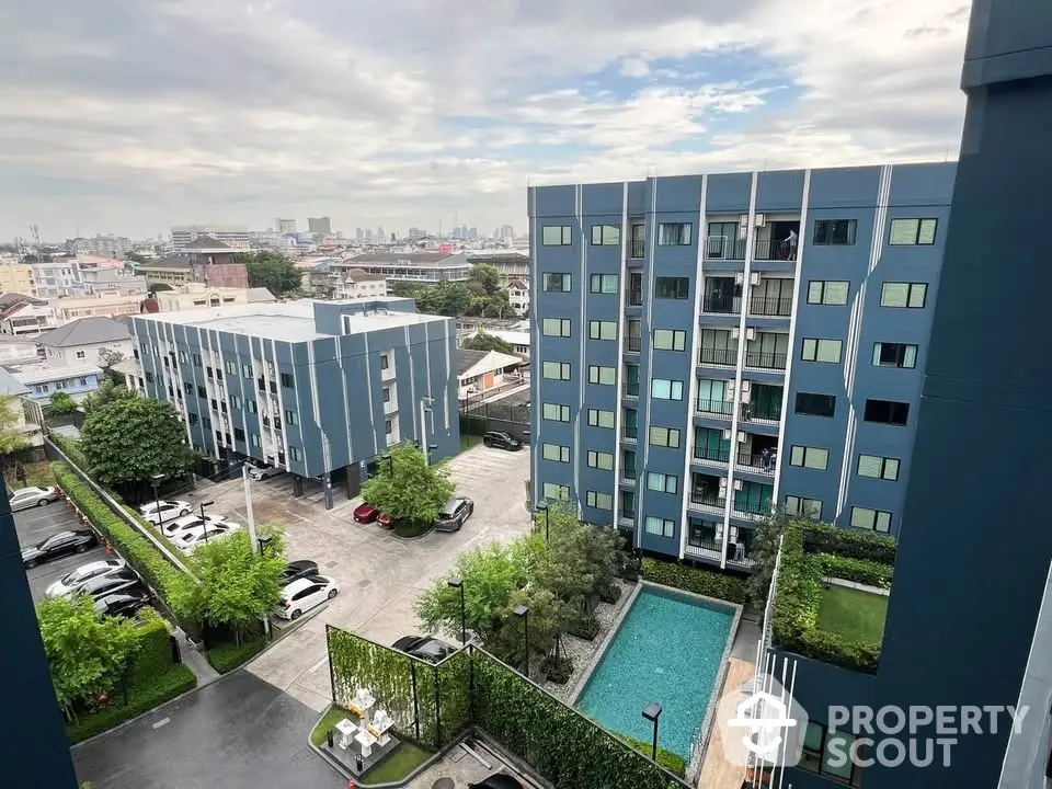 Modern apartment complex with pool and city view