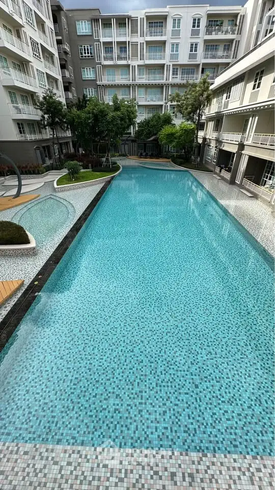 Luxurious residential complex with a stunning outdoor pool and modern architecture.