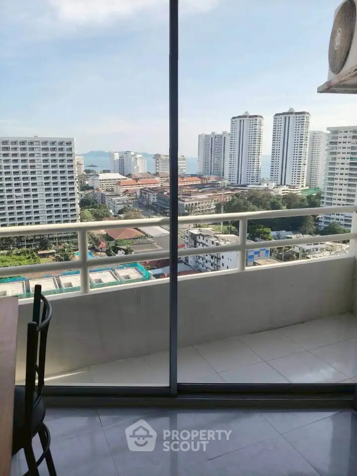 Stunning high-rise balcony view with cityscape and ocean backdrop, perfect for urban living enthusiasts.