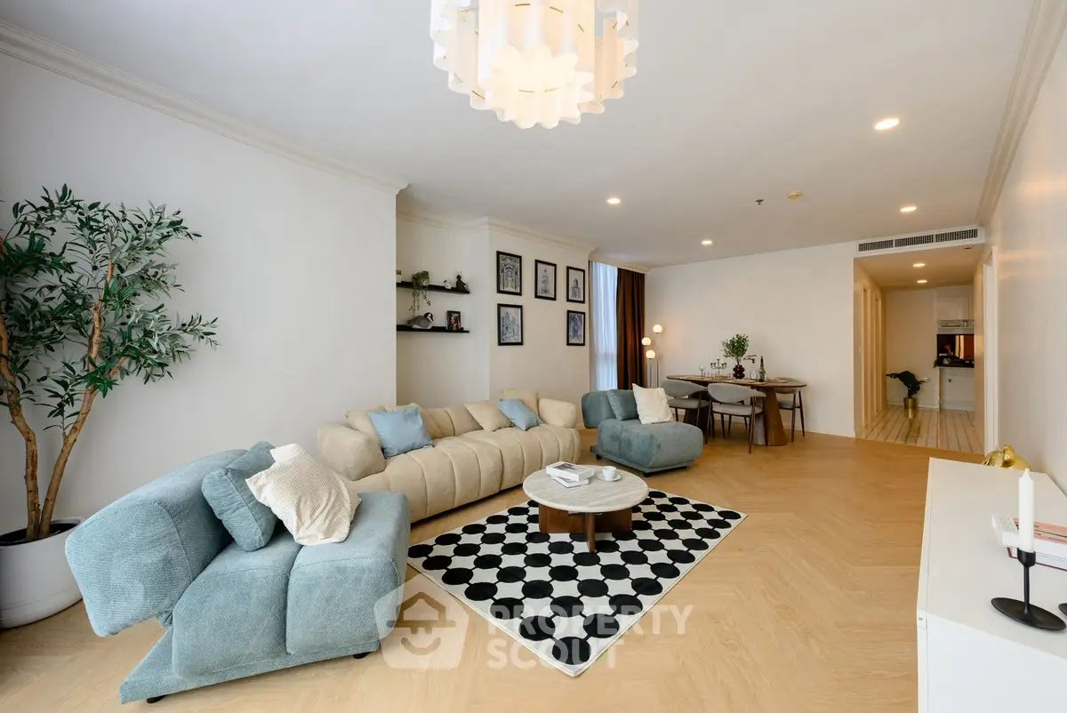 Spacious modern living room with stylish decor and open dining area, perfect for entertaining.