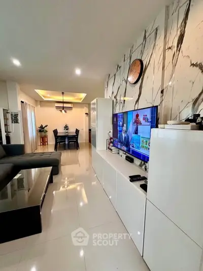 Luxurious modern living room with marble accent wall and sleek furniture