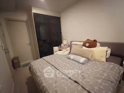 Cozy bedroom with plush bedding and modern decor in a stylish apartment.