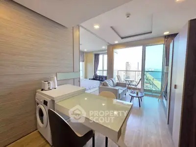 Modern open-plan living room with washing machine and balcony view