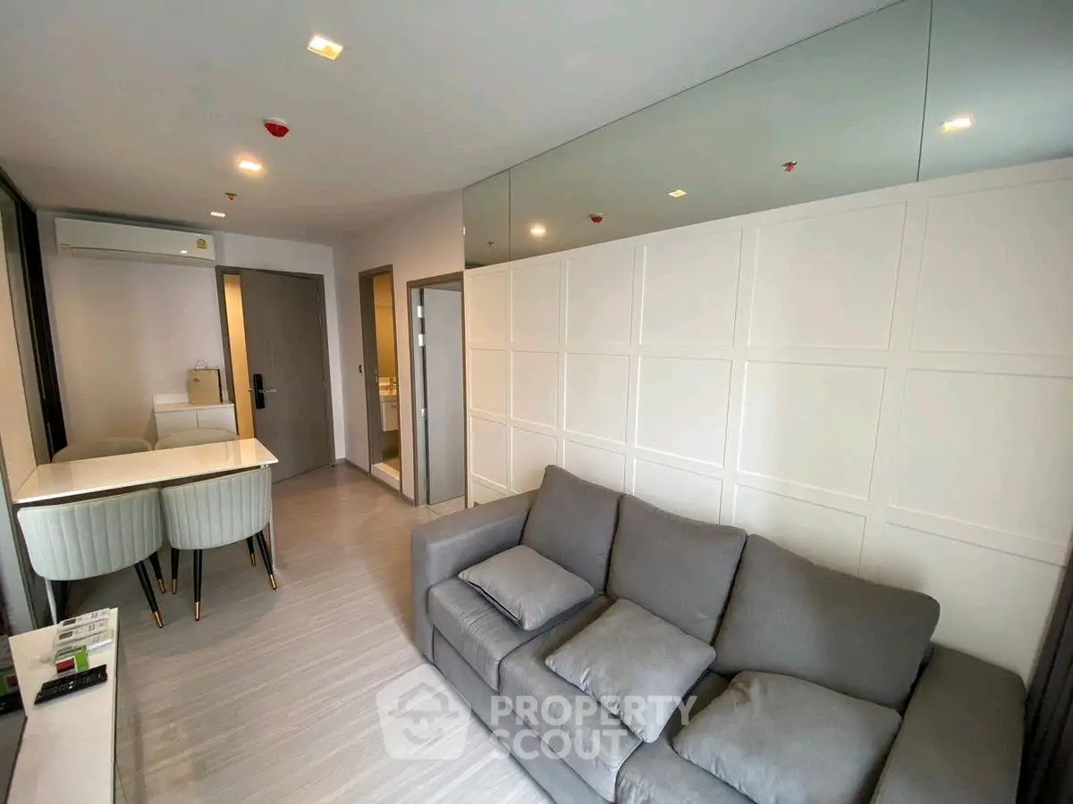 Modern living room with sleek design and comfortable seating in stylish apartment.