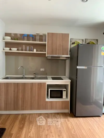 Modern kitchen with sleek wooden cabinets and stainless steel appliances