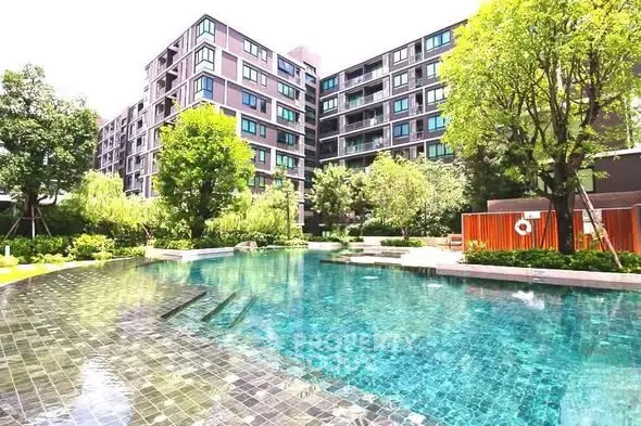 Luxurious residential building with stunning pool and lush greenery