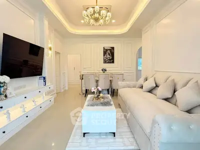 Luxurious living room with elegant decor, plush sofa, and modern chandelier in a stylish home.