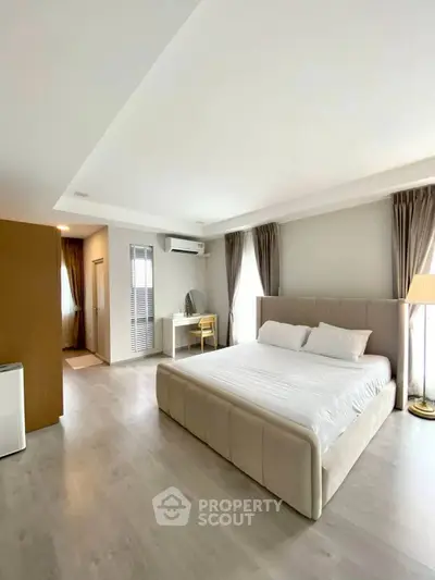 Spacious modern bedroom with elegant decor and natural light
