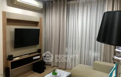 Cozy living room with modern TV setup and elegant curtains