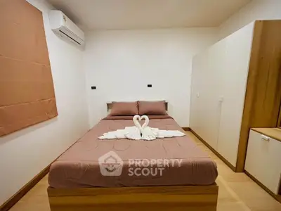 Cozy bedroom with stylish decor and air conditioning unit