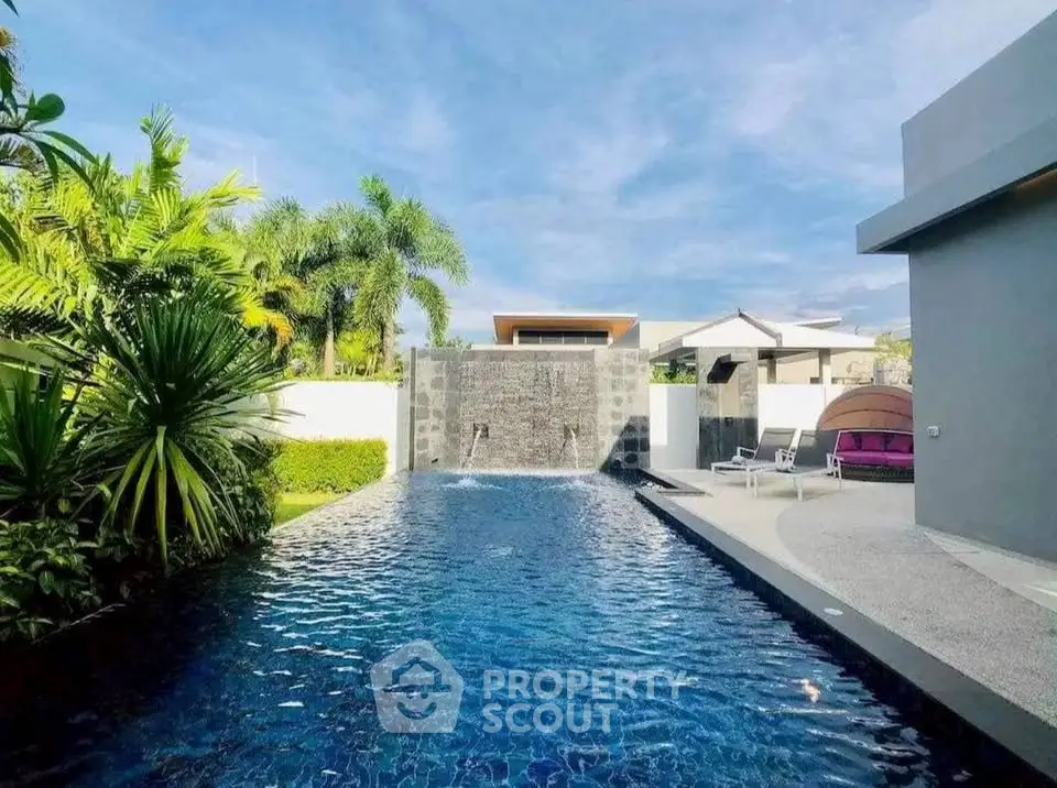 Luxurious outdoor pool with modern design and lush greenery, perfect for relaxation and entertainment.