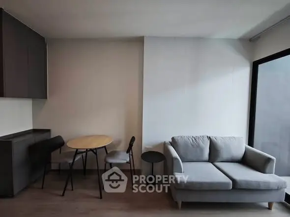 Modern living room with cozy gray sofa and stylish dining area