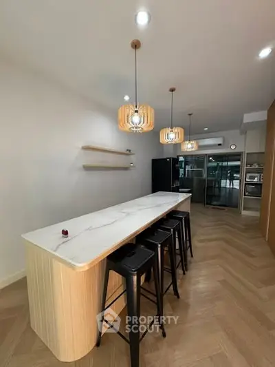 Modern kitchen with sleek island and stylish pendant lights